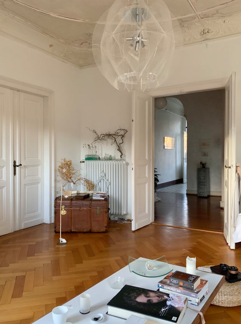 Bright living room with herringbone hardwood flooring showcasing elegant wood plank floor pattern in a modern interior space