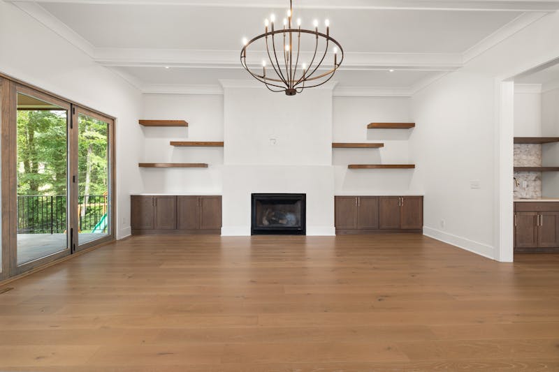 Modern living room with hardwood flooring and fireplace highlighting natural oak wood floor in a spacious residential interior